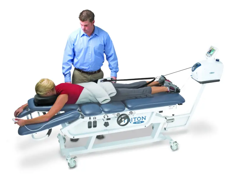 A patient lying face-down on the Triton DTS spinal decompression table